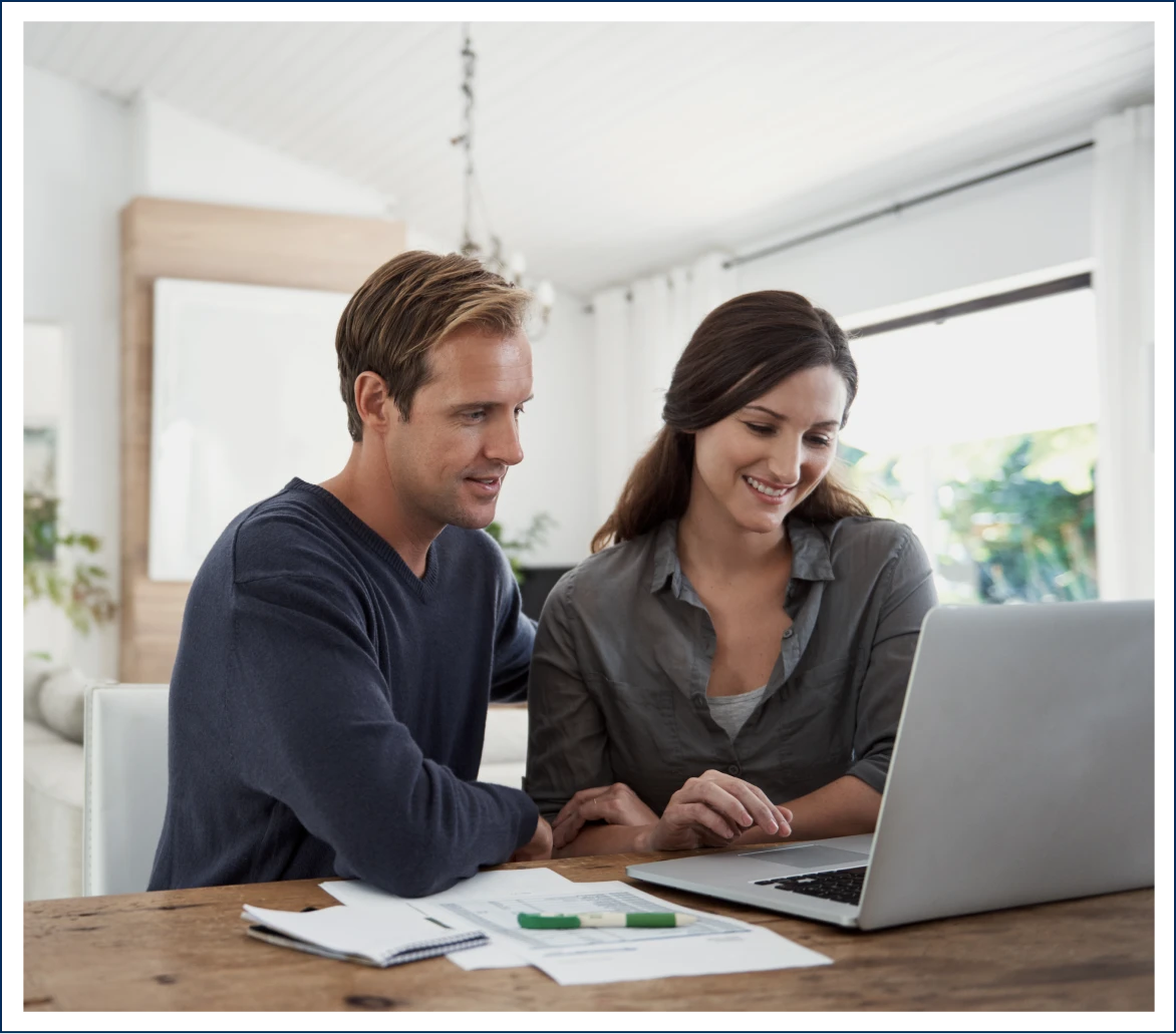 Smiling couple using computer