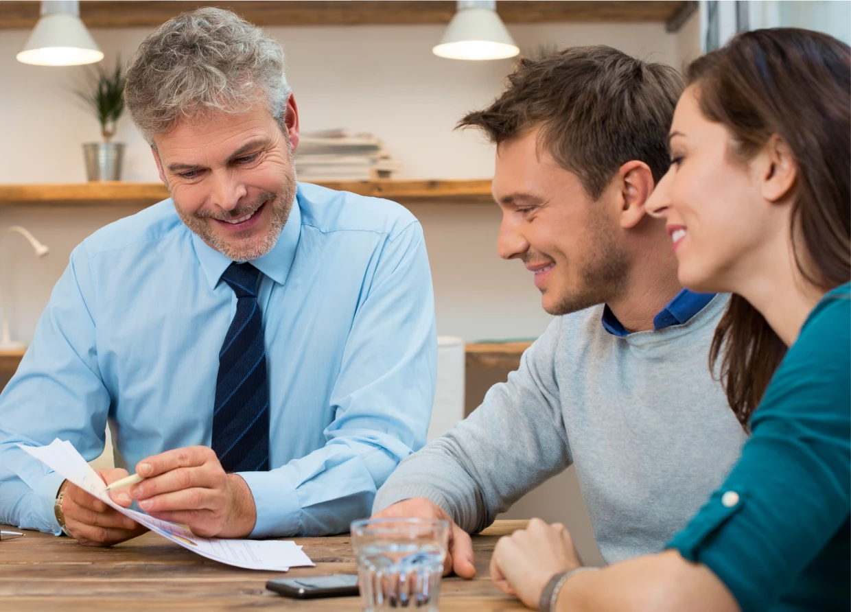 Man showing documents to smiling couple